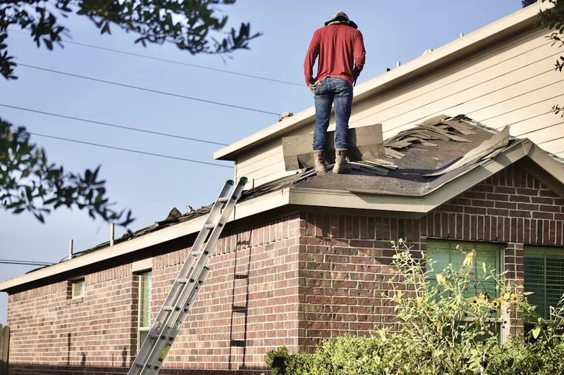 Professional roofer working on a residential roof in South Charleston